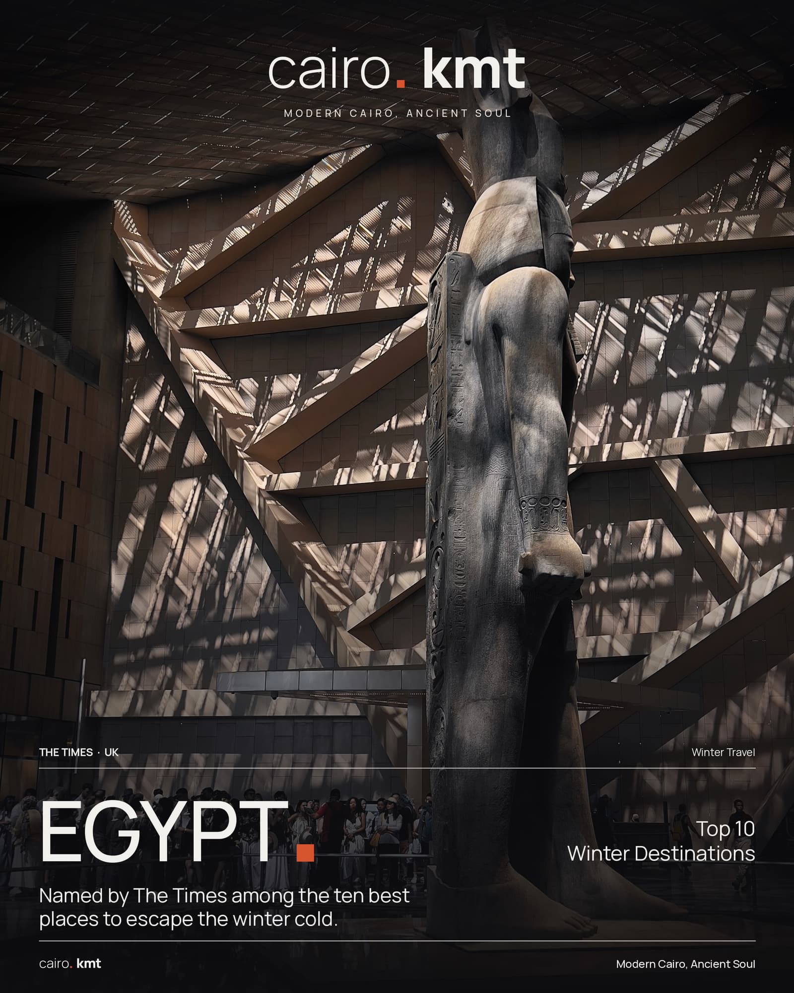 A colossal statue inside the Grand Egyptian Museum, under the word EGYPT