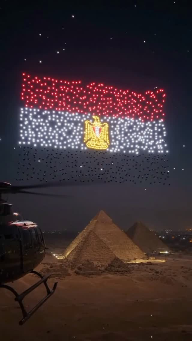 A drone show forms the Egyptian flag above the pyramids