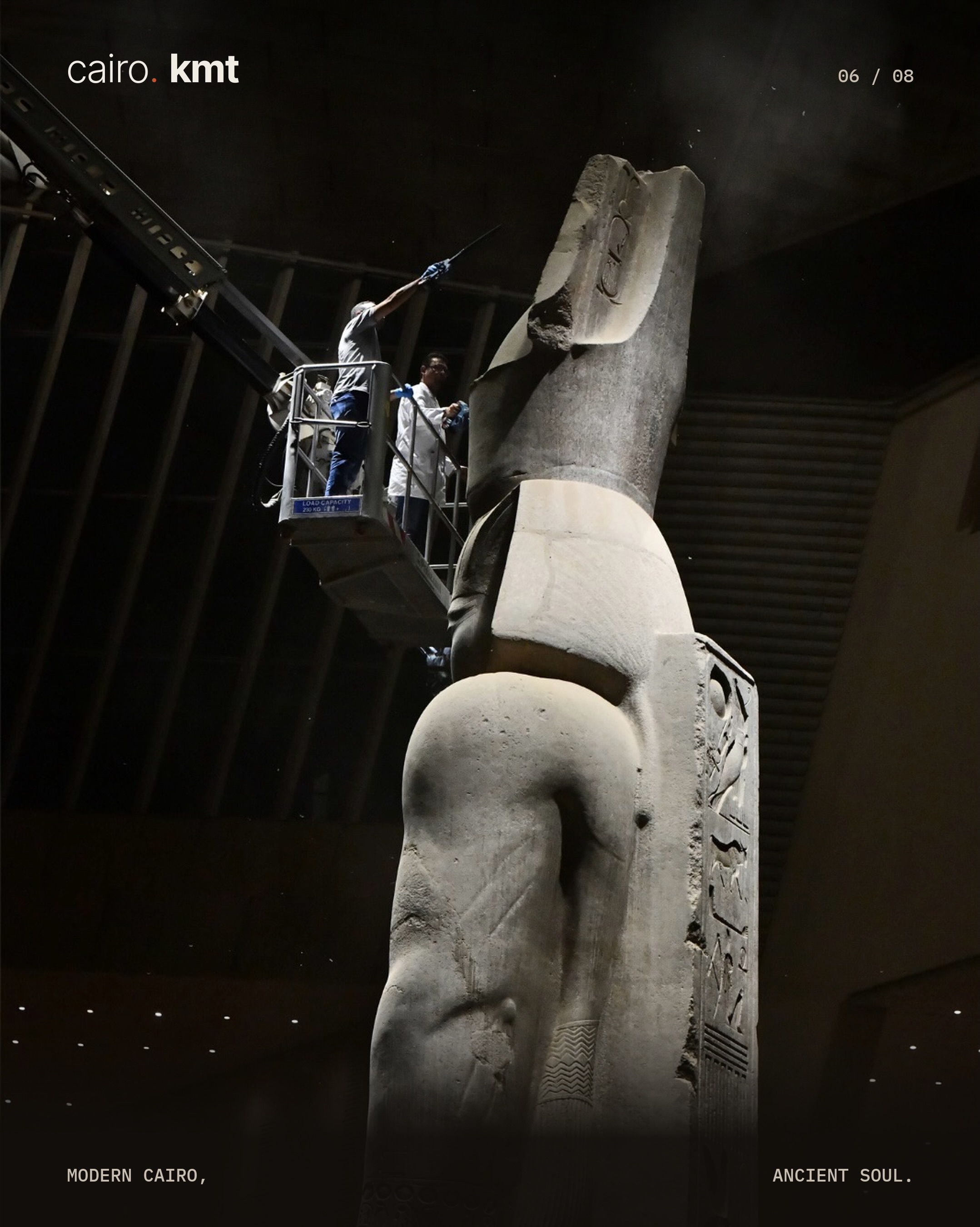 A conservator cleans the colossal statue of Ramesses II