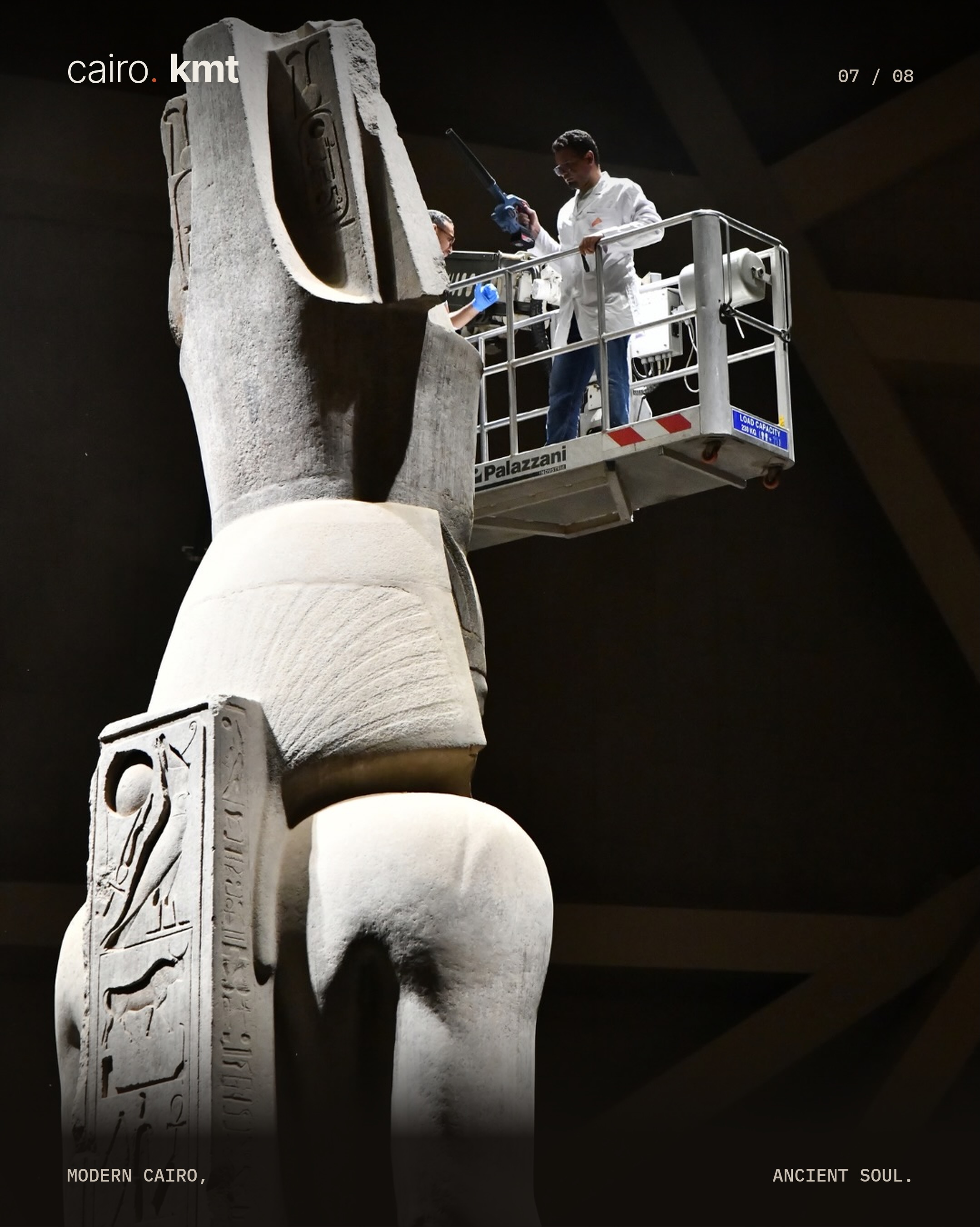 A conservator cleans the colossal statue of Ramesses II