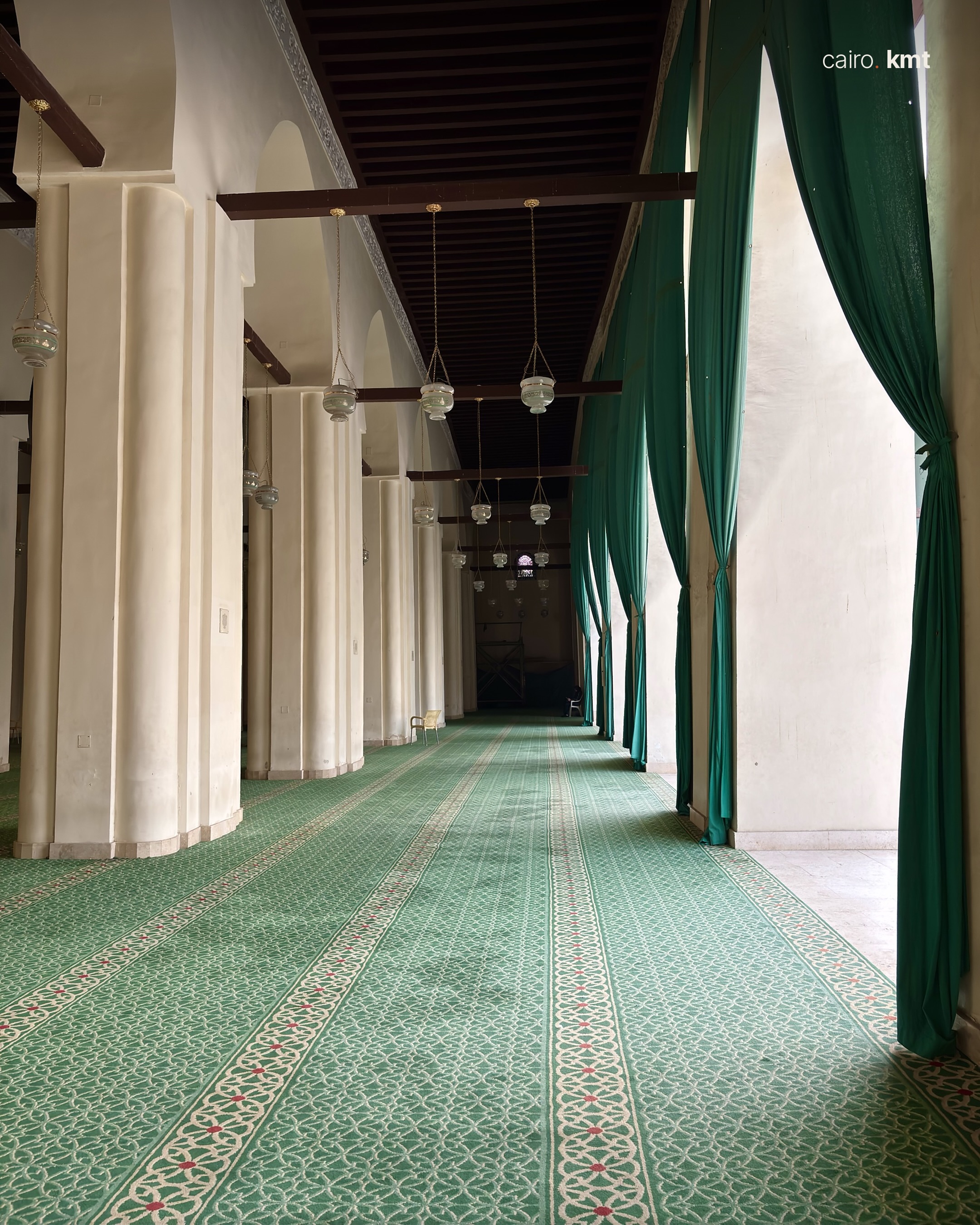 The courtyard of the Mosque of al-Hakim seen through green curtains