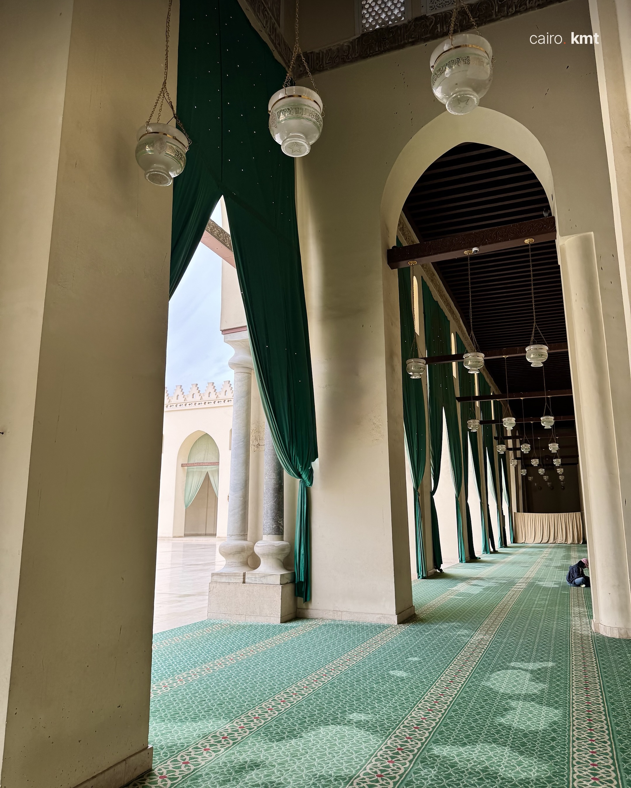 The courtyard of the Mosque of al-Hakim seen through green curtains